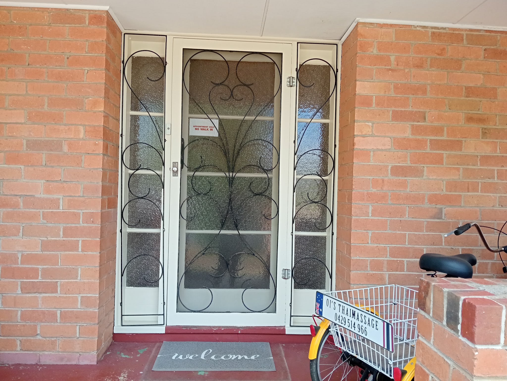 The studio's front door with an Appointment Only sign and a bicycle basket sign reading OI'S THAIMASSAGE 0429 514 966